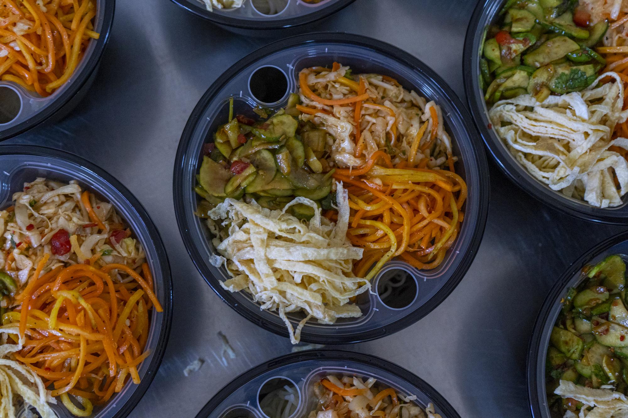 Stack of prepared meal bowls for delivery